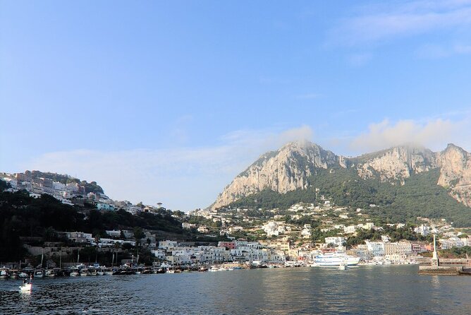 Capri & Blue Grotto: Full-Day Tour with Guided Island Exploration - Entering the Blue Grotto by tiny rowboat