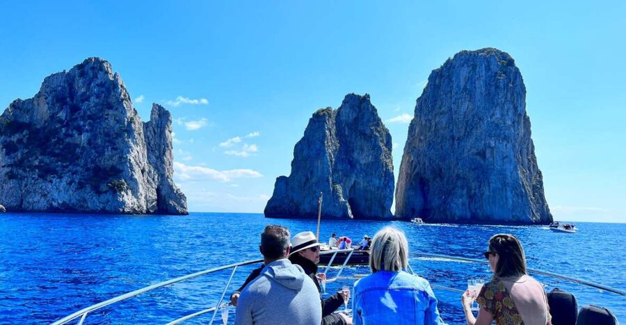 Discover Capri's Hidden Gems: Group Tour Boat Experience - Passing the Faraglioni rocks