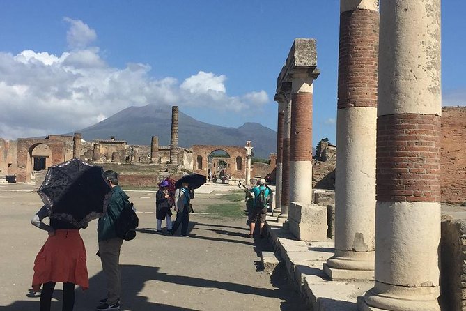 Pompeii Express Guided Tour by Train from Sorrento - Pompeii under sun, rain, and uneven stones